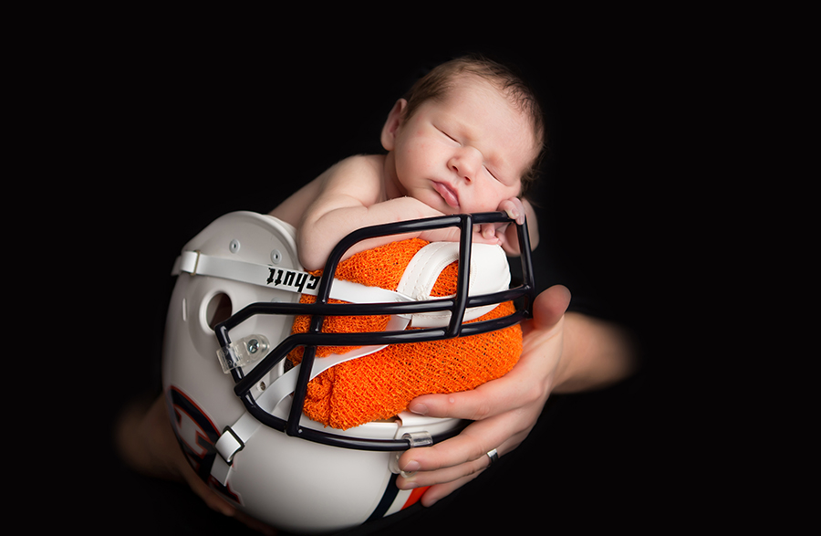 Newborn in Football helmet