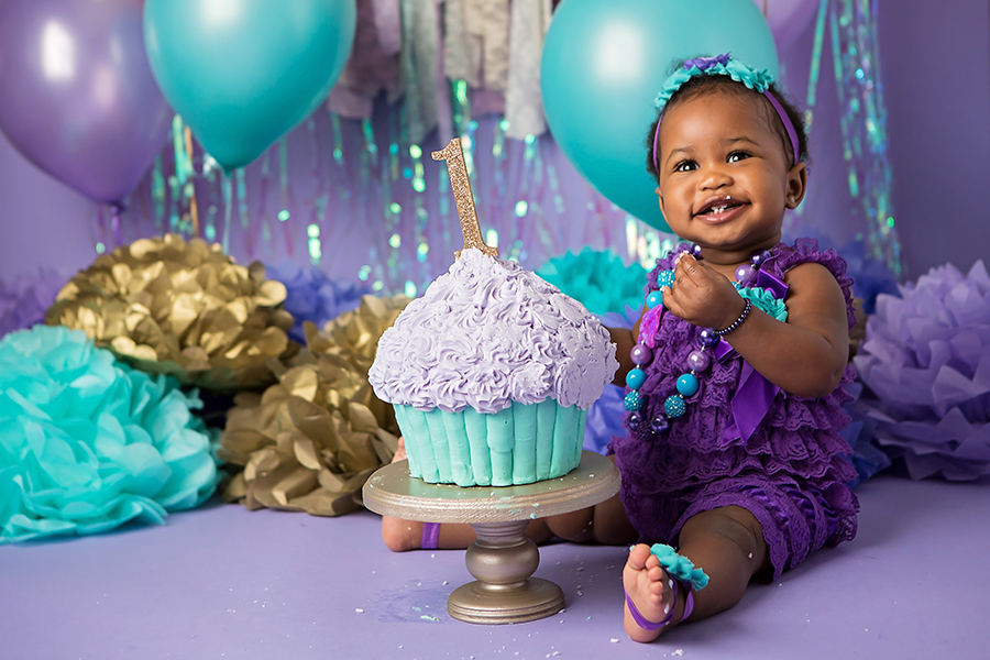 Little girl smiling eating cake