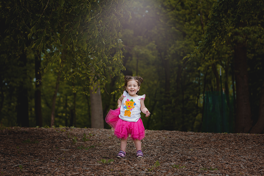 Little girl standing in the woods