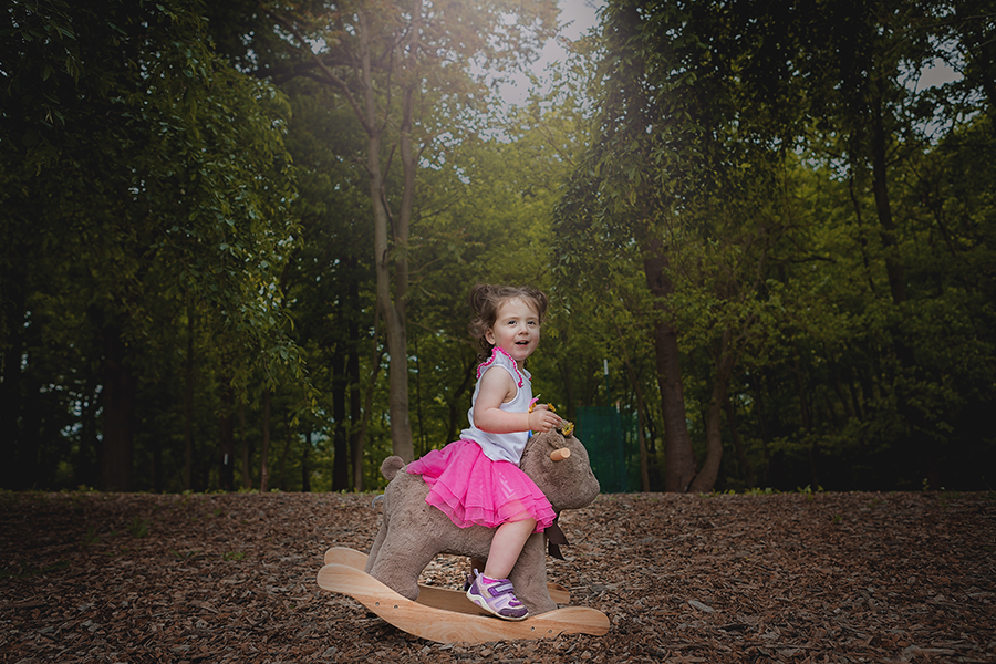 Little kid playing on a rocking horse