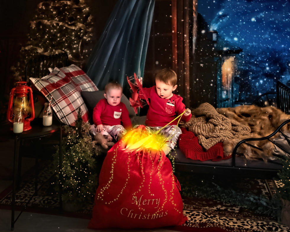 small children look into santas magical bag of toys