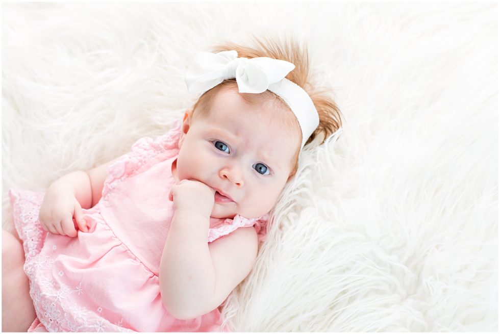red headed baby girl with white bow