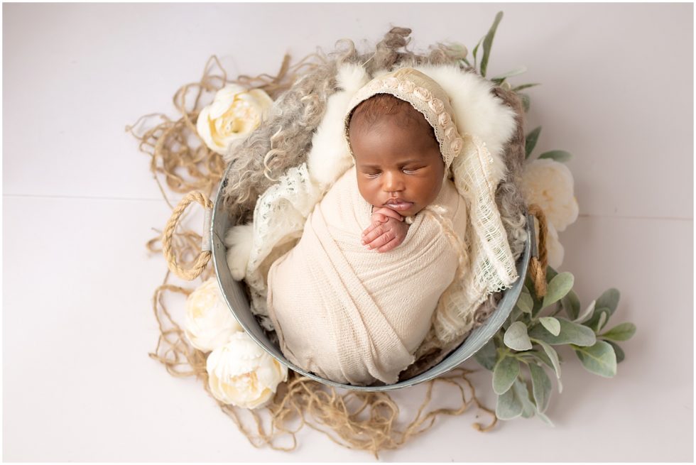newborn baby swaddled in earth tones