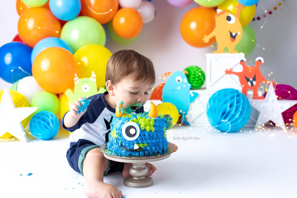 baby boy bites into monster cake