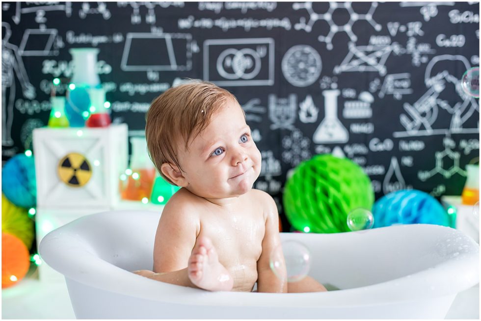 baby boy has bath after cake in science lab set