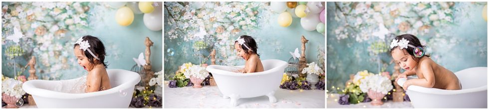 baby girl splashes in mini tub surrounded by flowers