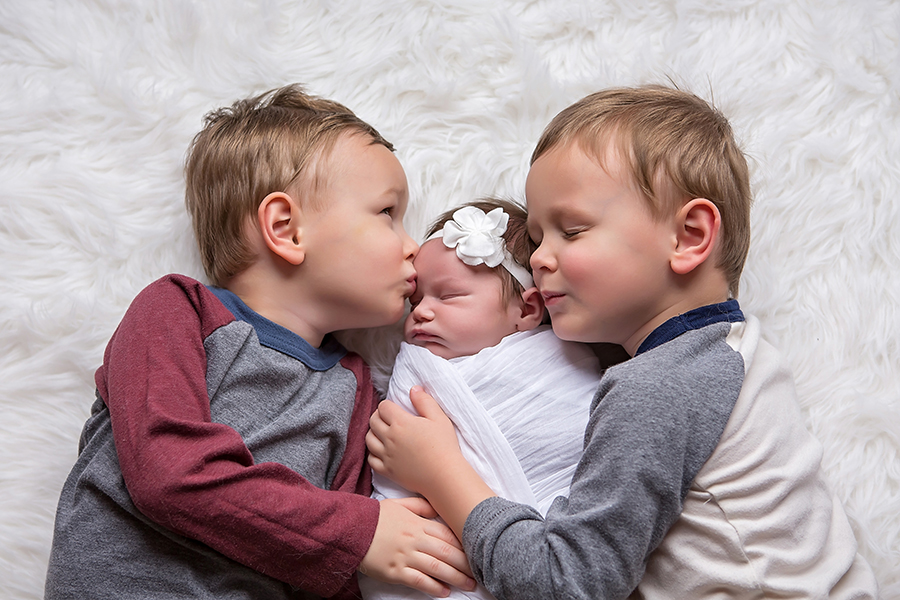 Newborn baby with their older brothers