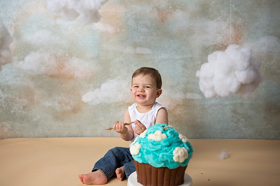 Little boy smiling eating cake