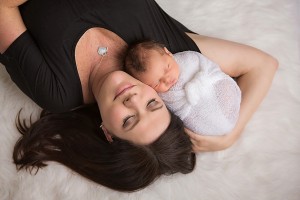Mother cuddling her newborn baby